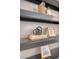 Staged bookshelf featuring books, art and decorative items adds a personal touch to the home's interior at 1800 Palmetto Isle Dr, Mount Pleasant, SC 29466