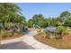 Beautifully landscaped community park with playground, lush greenery, and inviting entrance sign at 1800 Palmetto Isle Dr, Mount Pleasant, SC 29466