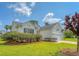 Charming single-Gathering home features lush landscaping, an attached garage, and a well-maintained lawn at 1800 Palmetto Isle Dr, Mount Pleasant, SC 29466