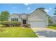 Inviting single-story home with a two-car garage and lush, green lawn at 1800 Palmetto Isle Dr, Mount Pleasant, SC 29466