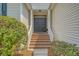 Inviting front entrance with brick steps, complemented by fresh landscaping and a classic double door at 1800 Palmetto Isle Dr, Mount Pleasant, SC 29466