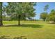 Picturesque view of the golf course with manicured lawns and mature trees at 1800 Palmetto Isle Dr, Mount Pleasant, SC 29466