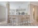 Bright kitchen features a breakfast bar with modern stools and white cabinetry at 1800 Palmetto Isle Dr, Mount Pleasant, SC 29466