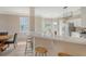 Open-concept kitchen with white cabinets, stainless steel appliances, and a breakfast bar overlooking the dining area at 1800 Palmetto Isle Dr, Mount Pleasant, SC 29466