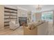 Bright living room featuring a fireplace, built-in shelves, and a comfortable seating arrangement at 1800 Palmetto Isle Dr, Mount Pleasant, SC 29466