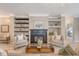 Cozy living room with a fireplace, built-in shelving, and elegant armchairs at 1800 Palmetto Isle Dr, Mount Pleasant, SC 29466