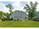 Backyard featuring raised garden beds, a patio, and a well-maintained lawn perfect for outdoor enjoyment at 1928 Gasque St, Johns Island, SC 29455