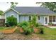 Backyard featuring raised garden beds, a patio, and a well-maintained lawn and tidy landscaping at 1928 Gasque St, Johns Island, SC 29455