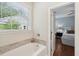 Bright bathroom showcasing soaking tub and natural light from a large window at 1928 Gasque St, Johns Island, SC 29455