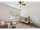 Cozy Bedroom with a crib, window, chair, and unique patterned rug at 1928 Gasque St, Johns Island, SC 29455