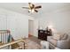 Bedroom with a crib, window, chair, and patterned rug at 1928 Gasque St, Johns Island, SC 29455