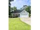 Charming one-story home with blue siding, a well-manicured lawn, and an attached two-car garage at 1928 Gasque St, Johns Island, SC 29455