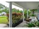 Inviting front porch featuring white columns, seating, and colorful plants with great curb appeal at 1928 Gasque St, Johns Island, SC 29455