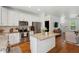 Bright kitchen features stainless appliances, island with granite countertop, and crisp white cabinets at 1928 Gasque St, Johns Island, SC 29455