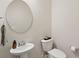 Stylish powder room features pedestal sink, round mirror, and modern fixtures at 1928 Gasque St, Johns Island, SC 29455