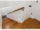 Hardwood stairway featuring wood railing and white trim at 1928 Gasque St, Johns Island, SC 29455