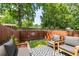 A cozy backyard with brick and patterned deck, wooden fence and mature trees at 201 Pine Shadow Dr, Goose Creek, SC 29445