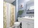 Bathroom with vanity, toilet, shower with green foliage themed curtain, and blue walls at 201 Pine Shadow Dr, Goose Creek, SC 29445
