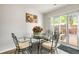 Cozy dining area features a glass-top table, elegant chairs, and sliding doors to the patio at 201 Pine Shadow Dr, Goose Creek, SC 29445