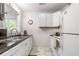 Bright kitchen with white cabinets, a stainless steel sink, and marble-look flooring at 201 Pine Shadow Dr, Goose Creek, SC 29445
