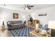 Cozy living room features stylish furniture, a ceiling fan, and a patterned blue rug at 201 Pine Shadow Dr, Goose Creek, SC 29445
