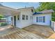 Spacious wooden deck extends from the house with neutral trim and gray shutters at 208 State St, Walterboro, SC 29488