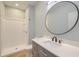 Bathroom with a sleek vanity, modern fixtures, and tiled shower at 208 State St, Walterboro, SC 29488