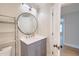 Bathroom featuring a vanity with a round mirror, and stylish fixtures at 208 State St, Walterboro, SC 29488