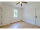 Bright bedroom with light wood floors, closet, and white walls at 208 State St, Walterboro, SC 29488