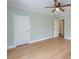 Spacious bedroom with hardwood floors, crown molding, and a ceiling fan at 208 State St, Walterboro, SC 29488