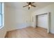 Bright bedroom featuring light wood floors, closet, and white walls at 208 State St, Walterboro, SC 29488