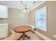 The breakfast nook has built-in seating and is lit by a decorative chandelier at 208 State St, Walterboro, SC 29488