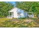 Charming home with a covered porch, white siding, and well-maintained yard at 208 State St, Walterboro, SC 29488