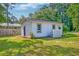 Home exterior with a fenced yard, manicured lawn, and lush greenery at 208 State St, Walterboro, SC 29488