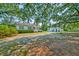 Charming two-story home with a detached building, surrounded by mature trees and lush yard at 208 State St, Walterboro, SC 29488