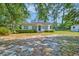 A charming single-story home with a well-manicured lawn and mature trees at 208 State St, Walterboro, SC 29488