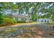 Charming home with a quaint front porch and lush greenery in a well-maintained yard at 208 State St, Walterboro, SC 29488