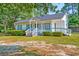 Inviting home featuring a cozy front porch and well-kept landscaping for a welcoming appeal at 208 State St, Walterboro, SC 29488