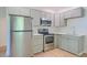 Bright kitchen featuring stainless steel appliances, light wood floors, and white countertops at 208 State St, Walterboro, SC 29488
