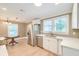 Updated kitchen with stainless steel appliances, white cabinetry, and a built-in breakfast nook at 208 State St, Walterboro, SC 29488