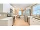 Full kitchen view featuring stainless appliances, bright white cabinetry, and hardwood floors at 208 State St, Walterboro, SC 29488
