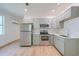 Well-lit kitchen featuring stainless steel appliances, white countertops, and light wood floors at 208 State St, Walterboro, SC 29488
