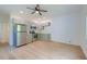 Open-concept kitchen featuring stainless steel appliances and light wood floors at 208 State St, Walterboro, SC 29488