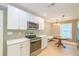 Bright eat-in kitchen features white cabinets, quartz countertops, and stainless steel appliances at 208 State St, Walterboro, SC 29488