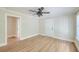 Inviting living room with modern flooring, a ceiling fan, and easy access to other rooms at 208 State St, Walterboro, SC 29488