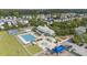 Aerial view of community amenities features a pool, clubhouse, playground, and manicured grounds at 209 Barberry St, Summerville, SC 29483