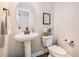 Chic powder room features a pedestal sink, round mirror, modern fixtures, and stylish decor, creating a welcoming space at 209 Barberry St, Summerville, SC 29483