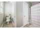 Clean bathroom featuring a toilet, shower with a patterned curtain, and neutral walls, creating a functional and tidy space at 209 Barberry St, Summerville, SC 29483