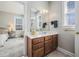 Bathroom view into bedroom showing vanity with storage and a mirror; seamless design connecting personal spaces at 209 Barberry St, Summerville, SC 29483