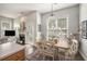 Open dining room adjacent to the kitchen showcases a dining table with seating and seamless flow to the fireplace and living area at 209 Barberry St, Summerville, SC 29483